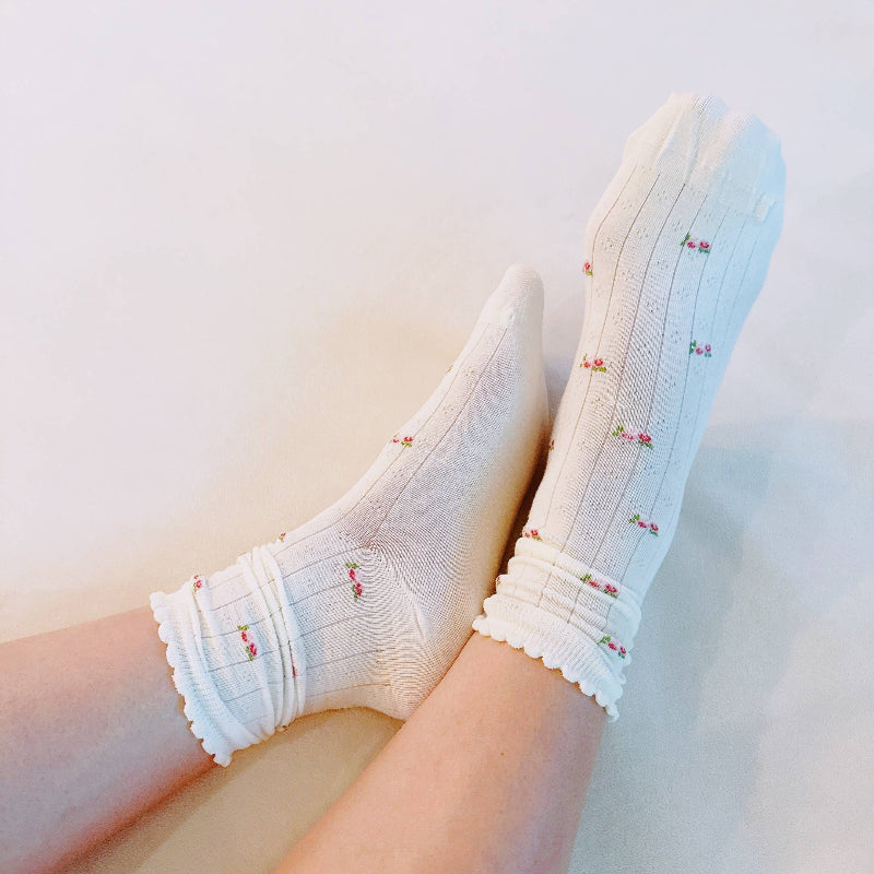 White socks with floral patterns on a light background