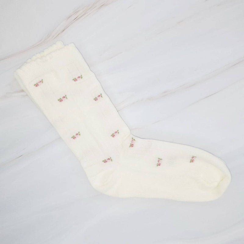 White sock with small patterns on a light gray background