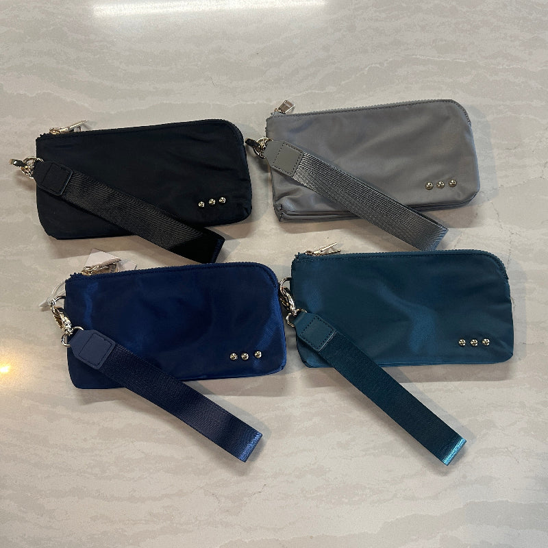 Four handbags in black, gray, and blue on a light-colored surface.