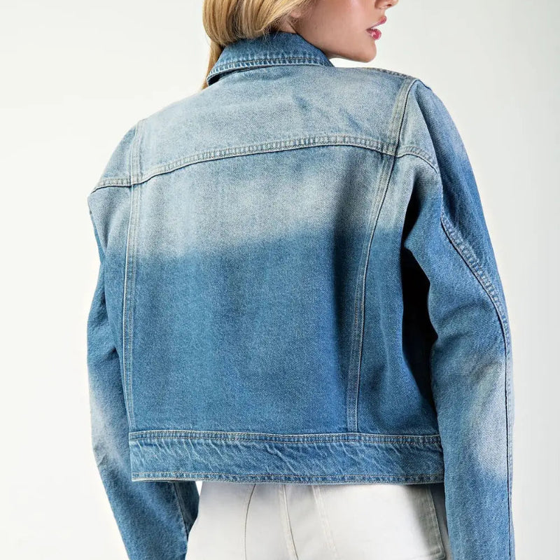 Person wearing a blue denim jacket on a white background