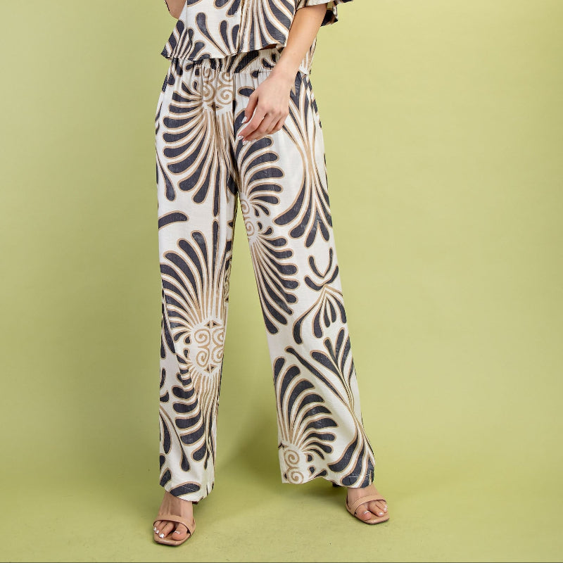 Woman wearing a patterned outfit on a green background