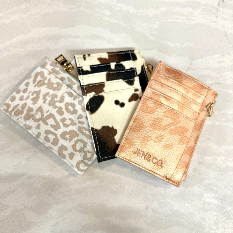 Three card holders with different designs on a light gray background