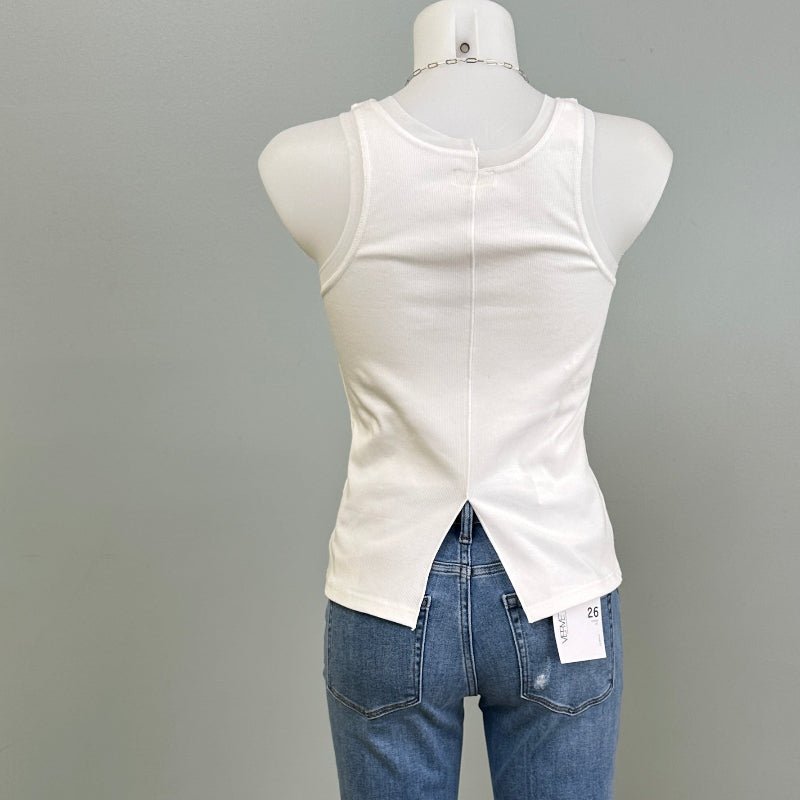 Mannequin wearing a white  tank top and blue jeans against a gray background
