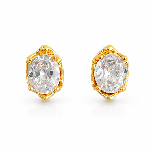 Gold earrings with clear gemstones on a white background