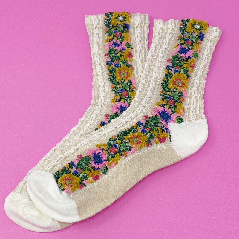 Pair of socks with floral pattern on a pink background