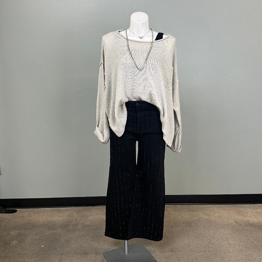 Mannequin wearing a gray sweater and black pants in a store setting