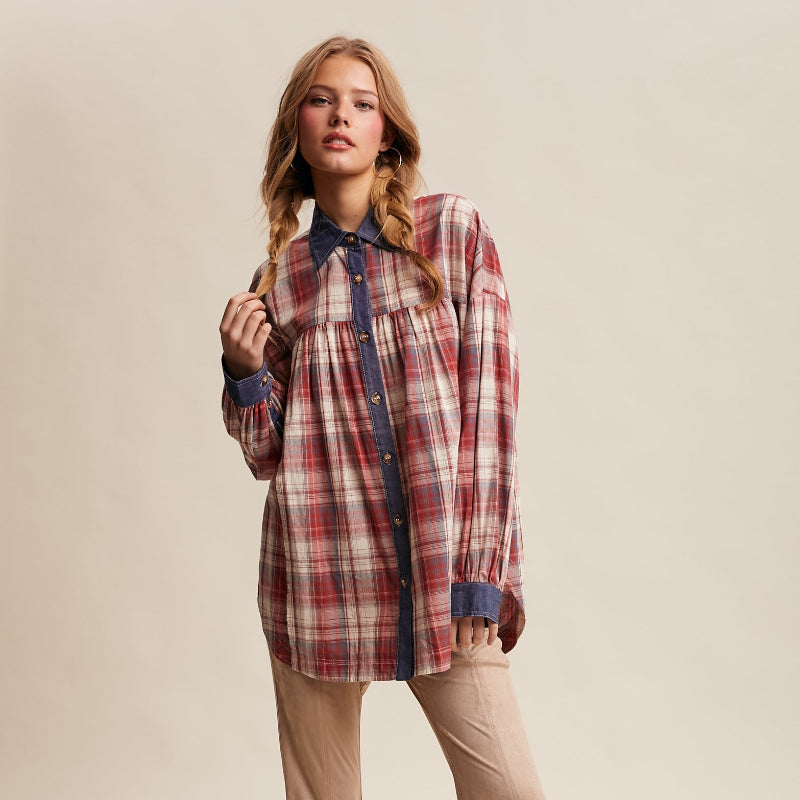 Woman wearing a plaid shirt and beige flared pants on a beige background