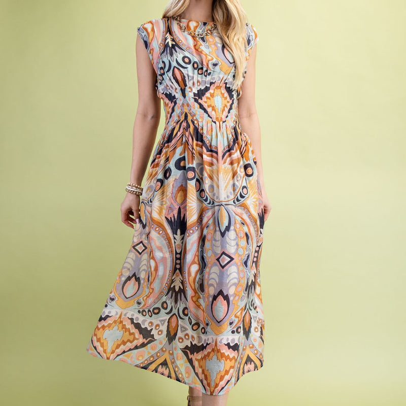 Woman wearing a patterned dress on a solid background