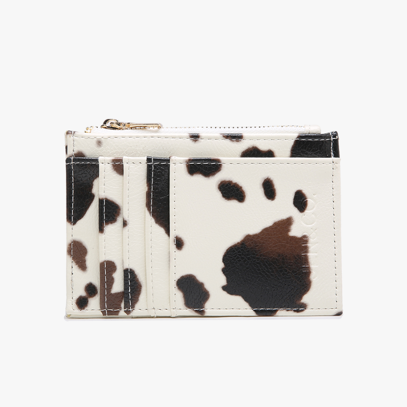 Cardholder with cow print design on a white background