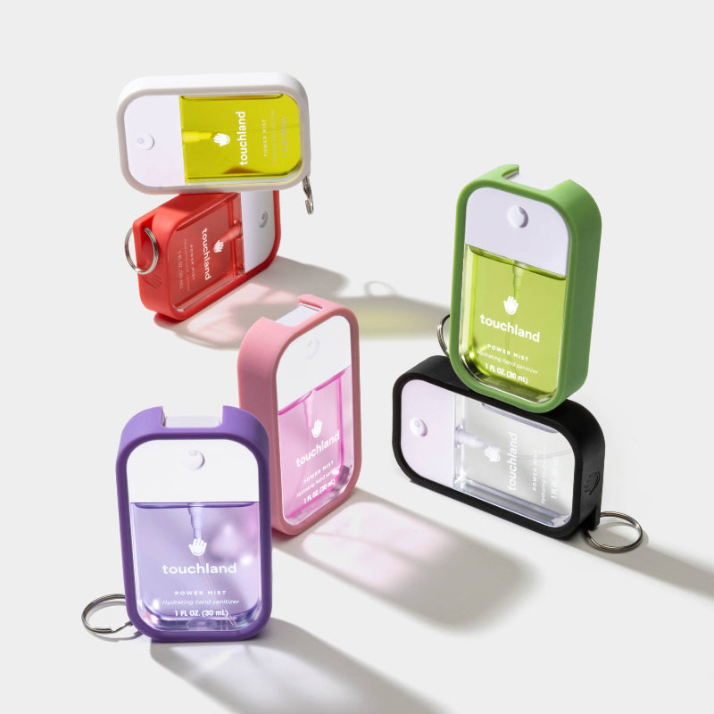 Colorful hand sanitizer holders with 'Touchland' branding on a white background